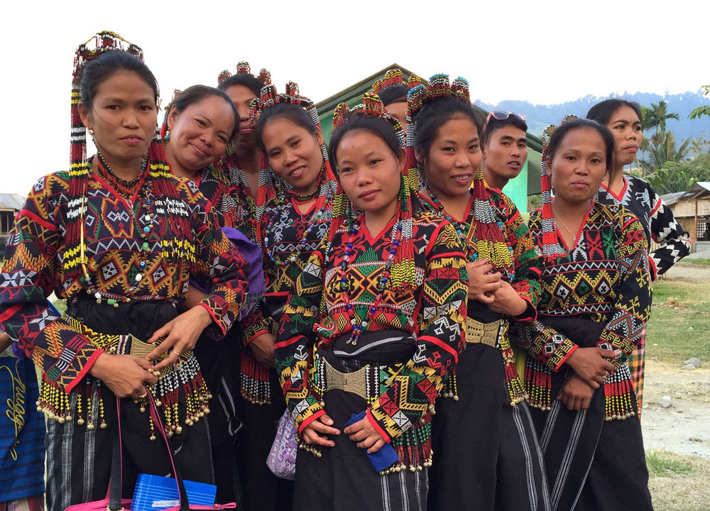 T'Boli women displaying their elaborate fabrics and embroidery .