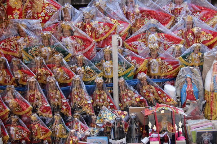 Catholic looking Santo Nilyo figures line a vendor stall outside of Cebu's Basilica del Santo Niño. 