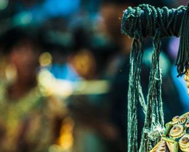 Half the face of a Lumad girl in beautiful traditional wear is shown on the right, while the left side is blurred through depth of field.