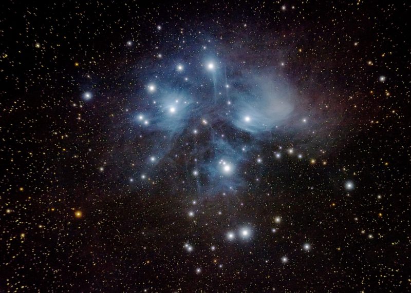 A long exposure photo of the Pleiades star cluster.