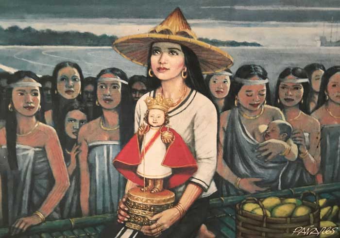 A Visayan woman holds a statue of the Santo Nino. She has a large hat blocking her head from the sun, a white shirt and an escort of maidens in the background.