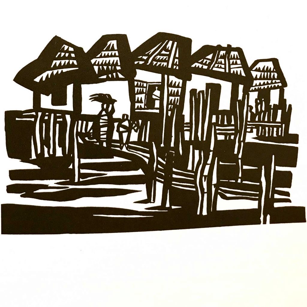 A oceanside village seen displayed as a woodcut.