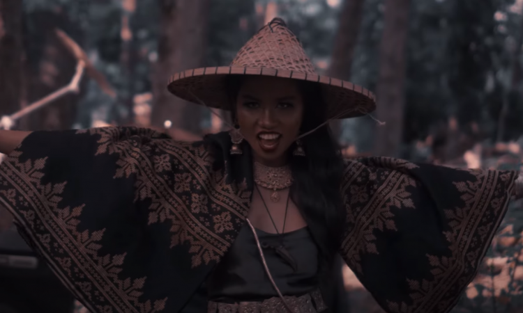 A woven parasol hat is worn by a precolonial looking Visayan woman.