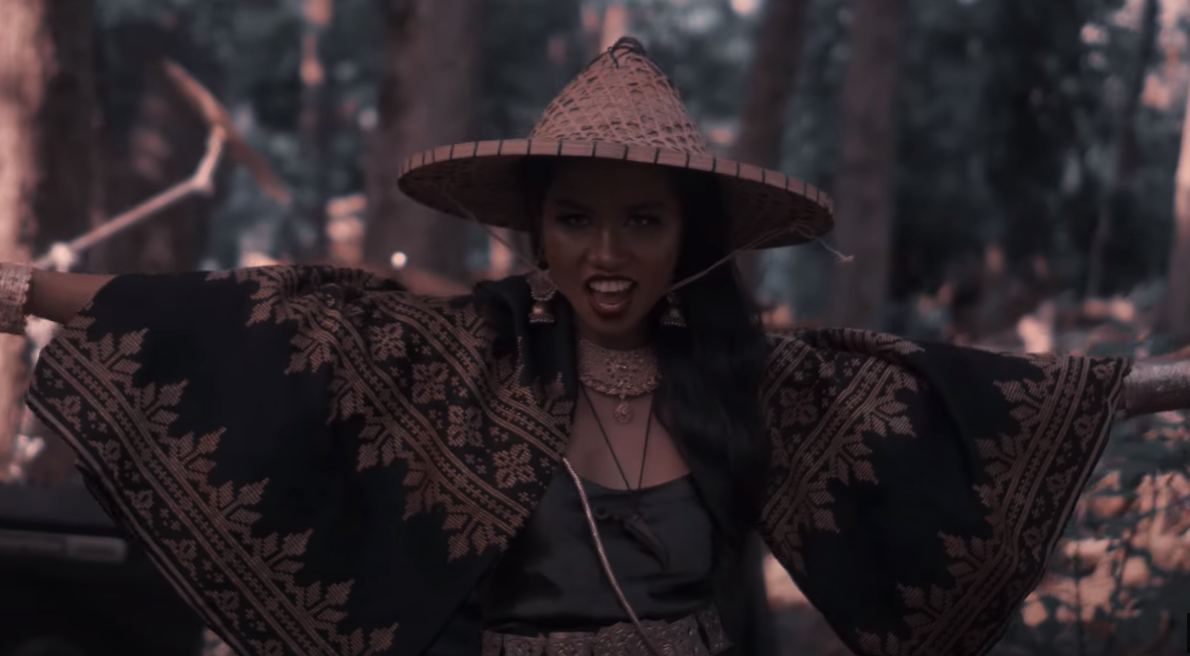 A woven parasol hat is worn by a precolonial looking Visayan woman.