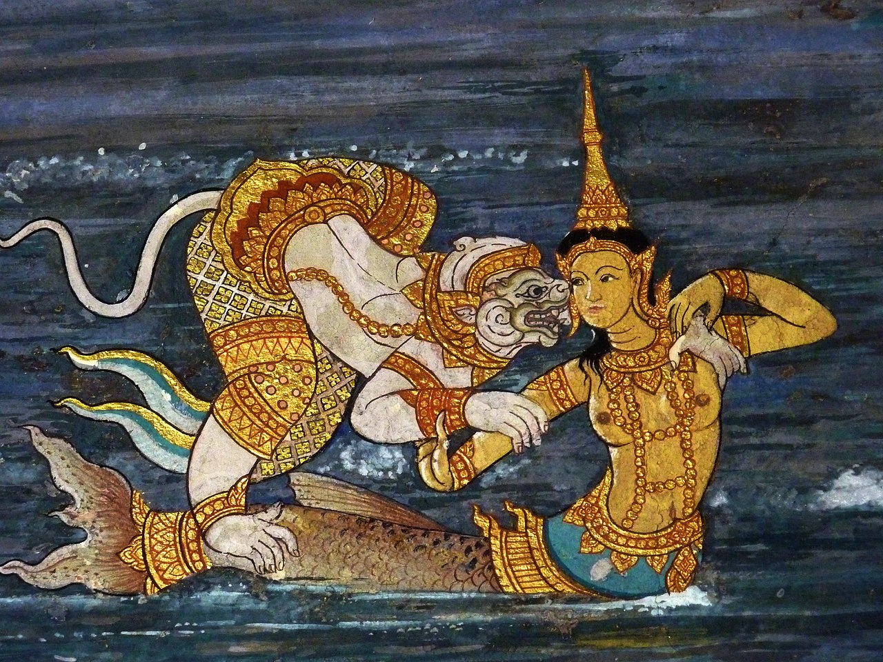 a mermaid is visited by a Hindu demon. Both are dressed in Thai Buddhist attire.