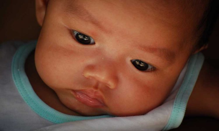 An infants face, close up.
