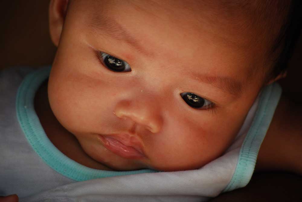 An infants face, close up.